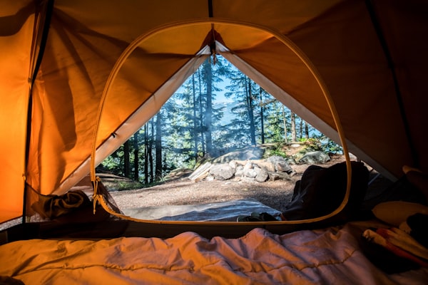 Alpine Pro Tent set up on a rocky mountain ledge at dusk